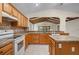 The kitchen is complete with an island, tile floors and backsplash, and modern appliances at 11094 Se 173Rd Ln, Summerfield, FL 34491