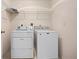 Convenient laundry area with washer, dryer, and shelving at 11094 Se 173Rd Ln, Summerfield, FL 34491
