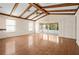Bright living room boasts wood floors, ceiling fan, and sliding glass doors to the outdoors at 11094 Se 173Rd Ln, Summerfield, FL 34491