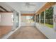 Enclosed sunroom with screens, a ceiling fan, and outdoor views at 11094 Se 173Rd Ln, Summerfield, FL 34491