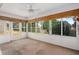 Enclosed sunroom featuring windows, ceiling fan, and carpeted flooring at 11094 Se 173Rd Ln, Summerfield, FL 34491