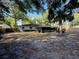 Spacious backyard featuring mature trees and a glimpse of the home's screened porch at 1120 Arden St, Longwood, FL 32750
