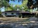 An expansive backyard with a screened-in porch is surrounded by beautiful trees and shrubs, providing privacy at 1120 Arden St, Longwood, FL 32750