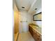 Bathroom featuring a vanity with a stone countertop, framed mirror, and glass-enclosed shower at 1120 Arden St, Longwood, FL 32750