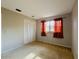 Bedroom featuring neutral walls, carpet floors and a window with orange curtains at 1120 Arden St, Longwood, FL 32750