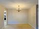 Light-filled dining area with a chandelier and cozy carpet, next to an entrance to the kitchen at 1120 Arden St, Longwood, FL 32750