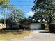 Charming single-story home featuring an attached two-car garage, inviting curb appeal, and mature trees at 1120 Arden St, Longwood, FL 32750