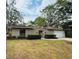 Charming single-story home featuring a well-maintained lawn, mature trees, and an attached two-car garage at 1120 Arden St, Longwood, FL 32750