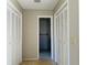 Hallway leading to bathroom with two white closet doors on either side at 1120 Arden St, Longwood, FL 32750