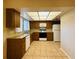 Functional kitchen featuring wood cabinetry, granite countertops, white appliances, and plenty of natural light at 1120 Arden St, Longwood, FL 32750