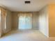 Bright living room featuring neutral walls, plush carpet, and large windows providing ample natural light at 1120 Arden St, Longwood, FL 32750