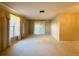 Sunlit living room boasts neutral walls, soft carpet, and large windows offering a bright and airy ambiance at 1120 Arden St, Longwood, FL 32750