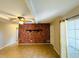 Spacious living room featuring a striking brick wall, neutral flooring, and ceiling fan at 1120 Arden St, Longwood, FL 32750