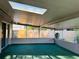 Enclosed patio with skylight, green carpet, and view of fenced yard at 1120 Arden St, Longwood, FL 32750