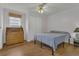 Simple bedroom with hardwood floor featuring a window, bed, closet, and dresser at 119 Jana Cir, Auburndale, FL 33823