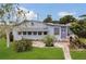 Inviting single-story home with neatly kept lawn, mature landscaping, and quaint front entrance at 119 Jana Cir, Auburndale, FL 33823