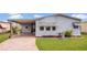 Charming single-story home with a covered carport, well-maintained lawn and landscaping, and peaceful neighborhood setting at 119 Jana Cir, Auburndale, FL 33823