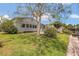 Charming single-story home with a well-maintained lawn, mature tree, and access to the waterfront at 119 Jana Cir, Auburndale, FL 33823