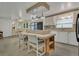 Bright kitchen featuring an island with counter seating, ample cabinetry, modern appliances, and tile flooring at 119 Jana Cir, Auburndale, FL 33823
