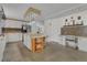 Bright kitchen featuring an island with counter seating, ample cabinetry, modern appliances, and tile flooring at 119 Jana Cir, Auburndale, FL 33823