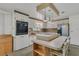 Bright kitchen featuring an island with counter seating, ample cabinetry, modern appliances, and tile flooring at 119 Jana Cir, Auburndale, FL 33823