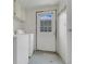 Laundry room featuring a washer, a dryer, a door to the outside, and overhead cabinets at 119 Jana Cir, Auburndale, FL 33823
