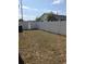 Spacious backyard featuring a white fence, lawn, and distant view of the home at 1250 Lemonwood Ave, Deland, FL 32724
