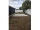Backyard with a white fence, concrete pavers, and partial view of screened-in porch at 1250 Lemonwood Ave, Deland, FL 32724