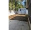 Backyard featuring a shed, white fence, patio, and green foliage at 1250 Lemonwood Ave, Deland, FL 32724