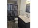 Bathroom featuring shower with stylish curtain, single sink vanity and tile flooring at 1250 Lemonwood Ave, Deland, FL 32724