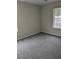Bedroom with neutral walls, blinds on the window, and plush gray carpeting at 1250 Lemonwood Ave, Deland, FL 32724