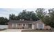 Charming single-story brick home featuring a well-maintained front yard and attached garage at 1250 Lemonwood Ave, Deland, FL 32724