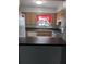 Well-lit kitchen with a breakfast bar, stainless steel sink, and white appliances at 1250 Lemonwood Ave, Deland, FL 32724