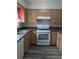 Functional kitchen featuring a white gas range, ample cabinet space, and durable countertops at 1250 Lemonwood Ave, Deland, FL 32724