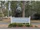 Entrance to the community, 'Lake Lindley Village', is marked by a welcoming sign amidst green foliage at 1250 Lemonwood Ave, Deland, FL 32724