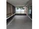 Enclosed sunroom featuring concrete flooring and sliding glass doors to backyard at 1250 Lemonwood Ave, Deland, FL 32724