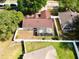 Aerial view of a fenced backyard with a screened patio and a well-maintained lawn at 1311 Fallwood Dr, Deltona, FL 32725