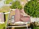 Aerial view of home with fenced yard, mature trees, a dark roof, and screened patio at 1311 Fallwood Dr, Deltona, FL 32725