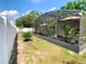 Fenced backyard includes a covered and screened patio, providing ample outdoor space at 1311 Fallwood Dr, Deltona, FL 32725
