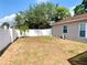 Spacious backyard features a privacy fence and leads to a screened in back patio at 1311 Fallwood Dr, Deltona, FL 32725