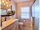 Bright bathroom features neutral tones, updated fixtures, and a shower behind glass doors at 1311 Fallwood Dr, Deltona, FL 32725