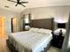 This bedroom has a king bed, dark furniture, a high vaulted ceiling with a ceiling fan at 1311 Fallwood Dr, Deltona, FL 32725
