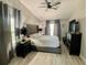 This bedroom has a king bed, dark furniture, and a ceiling fan with blinds letting in light at 1311 Fallwood Dr, Deltona, FL 32725