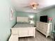Bedroom features a wooden bed frame, soft green walls, and a ceiling fan with a light at 1311 Fallwood Dr, Deltona, FL 32725