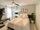 Comfortable bedroom with a ceiling fan, large windows, and neutral colored decor at 1311 Fallwood Dr, Deltona, FL 32725