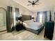 This bedroom has a king bed, dark furniture, and a high vaulted ceiling with a ceiling fan at 1311 Fallwood Dr, Deltona, FL 32725