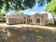 Attractive single-story home featuring a side-entry garage and a tidy front lawn at 1311 Fallwood Dr, Deltona, FL 32725