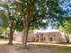 Inviting single-story home with well-maintained lawn and mature trees providing shade at 1311 Fallwood Dr, Deltona, FL 32725