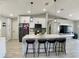 Bright kitchen with a large island, black bar stools, stainless appliances, and pendant lighting at 1311 Fallwood Dr, Deltona, FL 32725