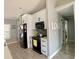 Bright kitchen with stainless appliances, white shaker cabinets, and gray backsplash at 1311 Fallwood Dr, Deltona, FL 32725